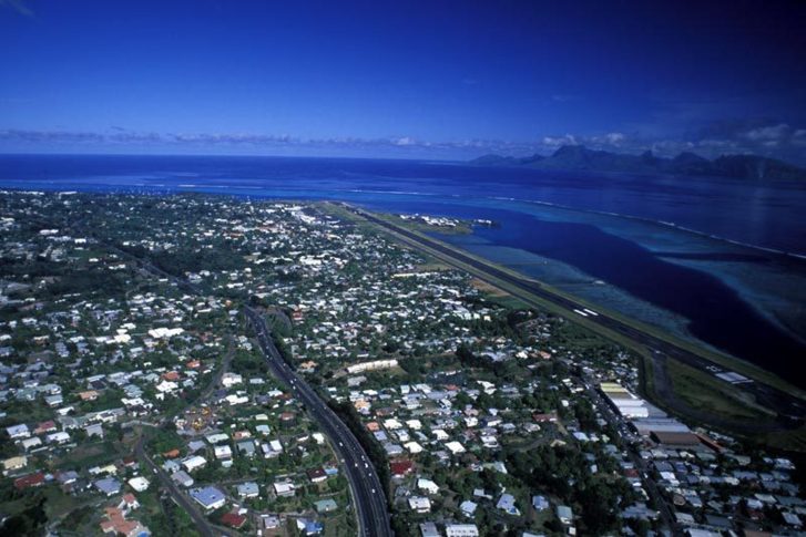 Vue aérienne de l'aéroport international "Tahiti - Faaa", de la commune de Faaa et vue sur l'île de Moorrea (c) Délégation de Polynésie Française à Paris.